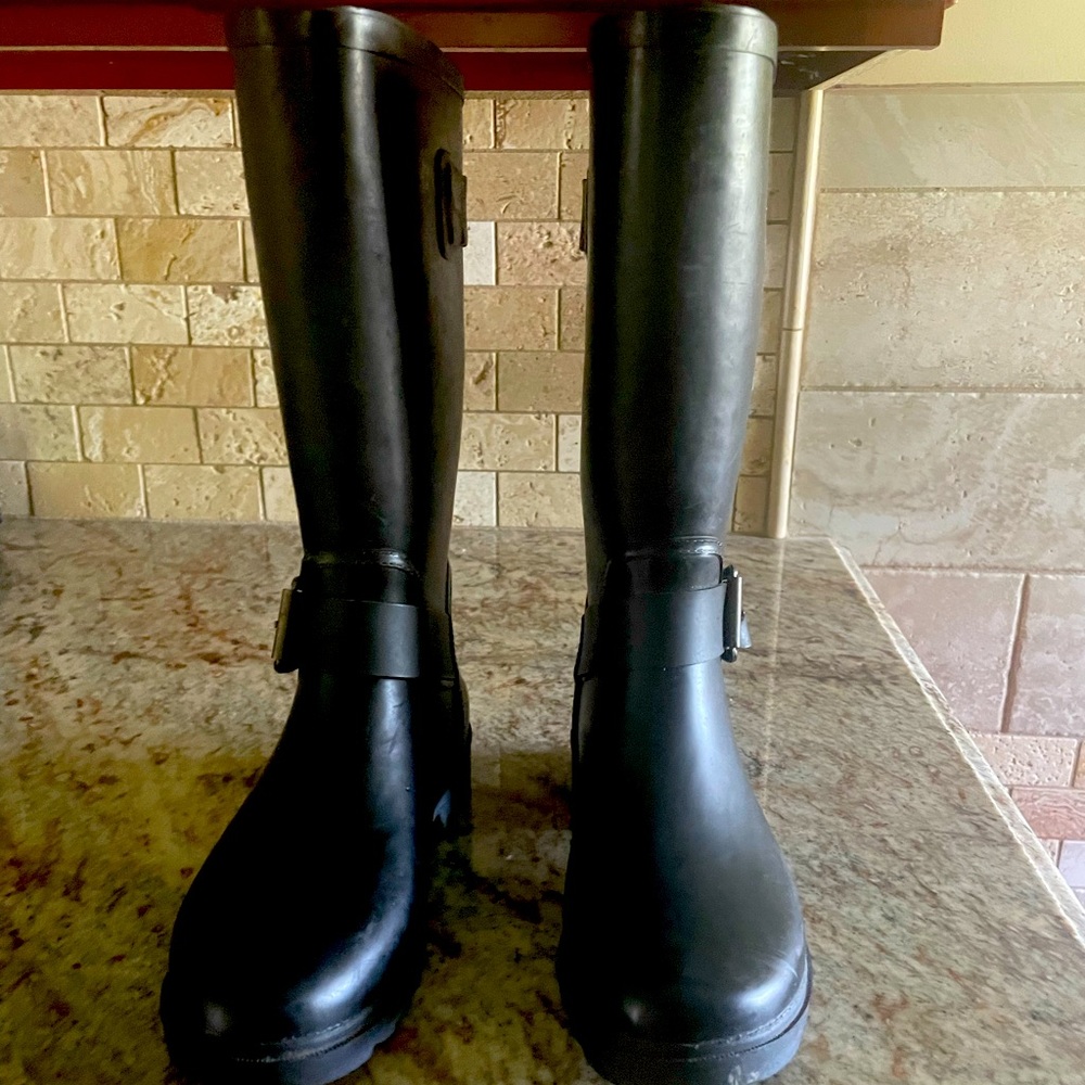Black, youth Justice rain boots made with leather and rubber.